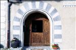 Typical entrance of an Engadine style house in the traditional Engadine village of Zuoz. Frescos decorate the arched entrance